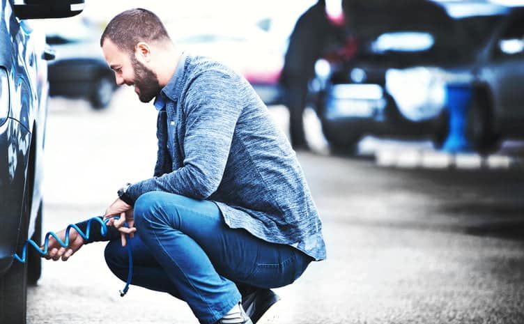 Man checking tyre pressure