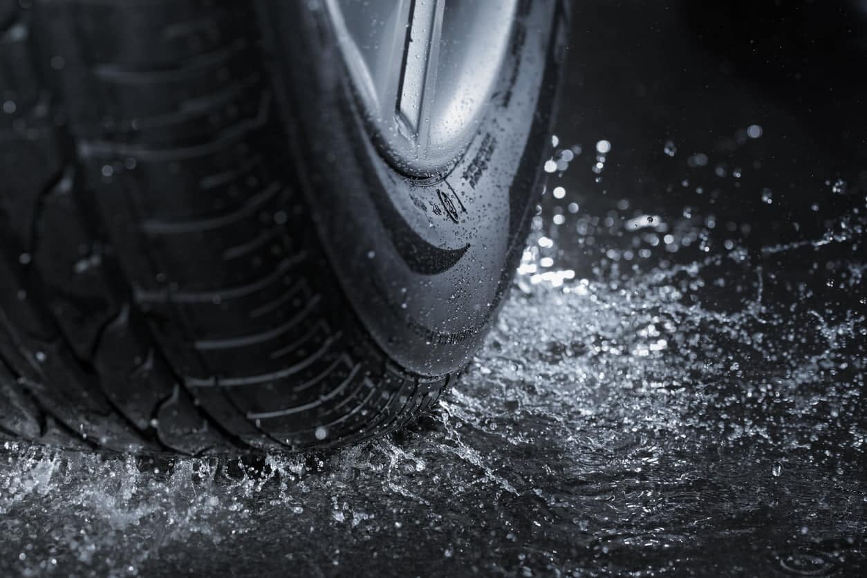 Car Wheel Splashing a Puddle