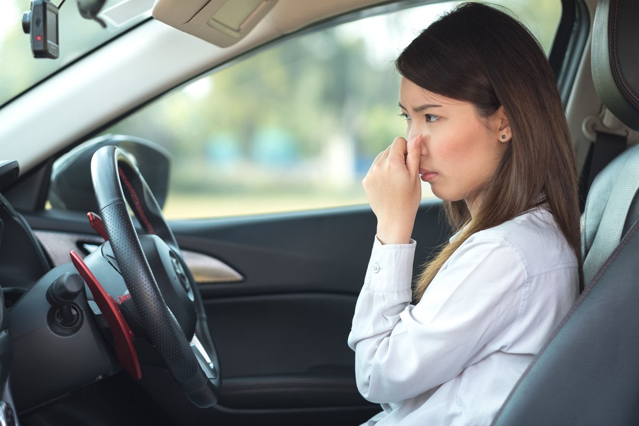 Women smells something wrong in her car