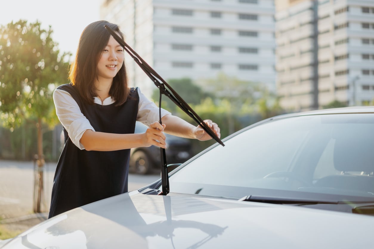 woman checking windshield wipers