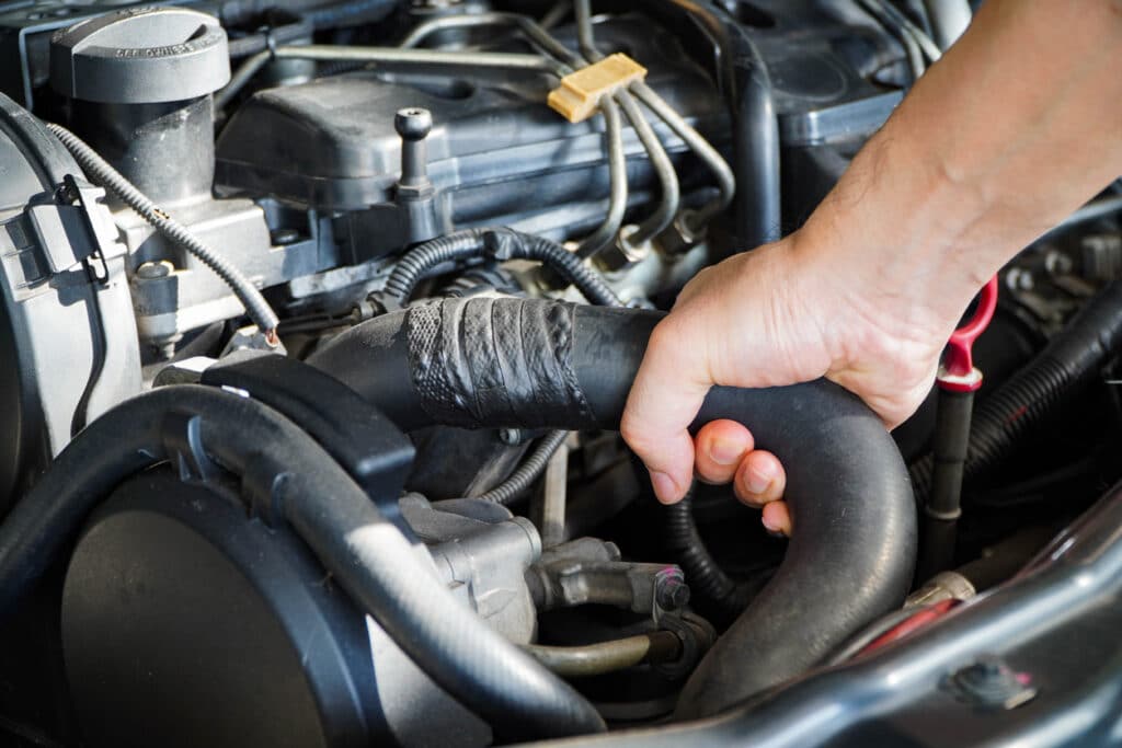 Technician to inspect radiator hose,Maintenance concept